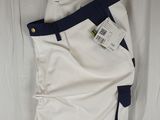 the white pants are hanging on a hanger on the wall