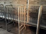 three metal beds in a row in a room