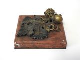 brass figurine of a grape and acorn on a wooden base