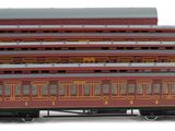 a red train car sitting next to another red train car