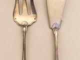 two forks and spoons are sitting side by side on a table