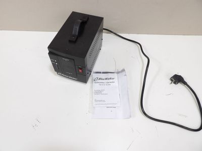 a black power supply sitting on a white table