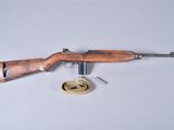 an old rifle is laying on a table next to a ribbon