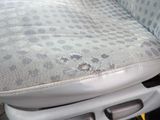 a dirty seat in the back of a car