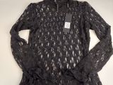 the shirt is black and has a lace pattern on it