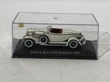 a silver model of a car in a clear display case