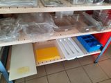 many plastic containers on a shelf in the kitchen