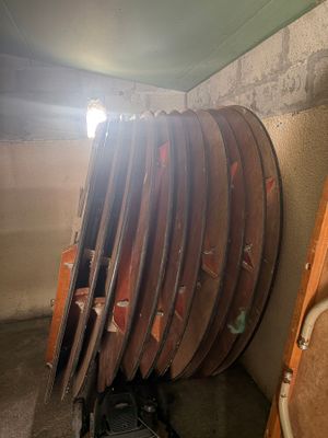 a lot of wooden boards stacked on top of each other in a room