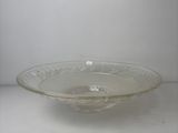 a glass bowl that is sitting on a shelf