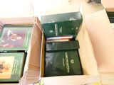 many books in a box sitting on the floor