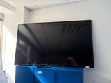 a large flat screen tv mounted on the wall in a room