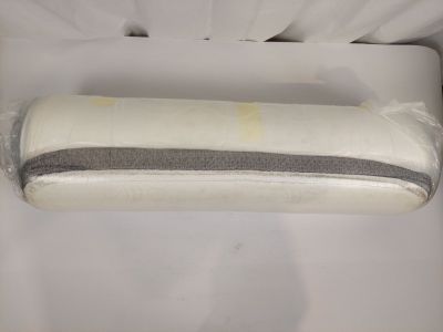 a roll of toilet paper wrapped in plastic on a bed