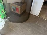 a glass table with a box on it next to a plant