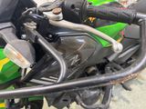 a close up of a green motorcycle parked in a garage