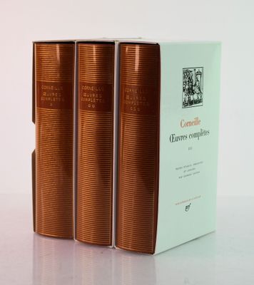 three books sitting on top of a white table next to each other