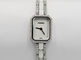 a close up of a wrist watch on a white surface