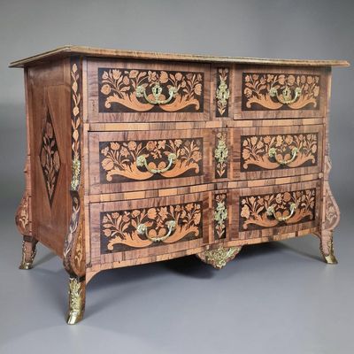 an image of a wooden chest of drawers with carvings on it