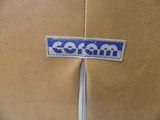 a brown jacket with a blue and white logo on it