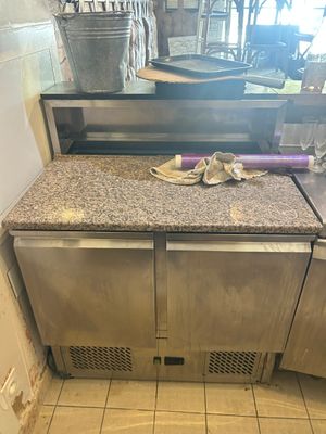 a kitchen with a sink and a counter with a dishwasher on it