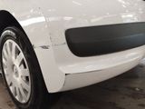a close up of a white car that is in a garage