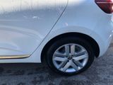 a close up of a white car parked in a parking lot