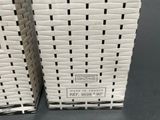 two white baskets stacked on top of each other on top of a table