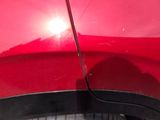 a close up of a red car ' s front bumper