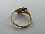 a close up of a gold ring with a diamond on it