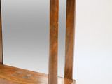 a small wooden table with a mirror on top of it
