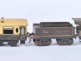 two toy trains sitting next to each other on a white surface