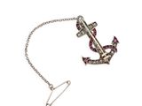 a close up of a necklace with an anchor on a chain