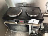 a stove with two burners on top of it next to a microwave