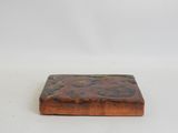 a small square wooden tray with a wooden surface