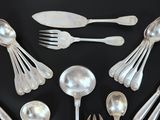 a lot of silver spoons and forks on the table