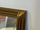 a mirror hanging on the wall next to a red rug