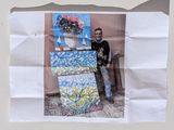 a picture of a man standing next to a painting on a piece of paper