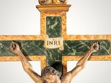 statue of jesus on the cross with the word inri written on it