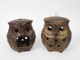pair of ceramic owl figurines on white background