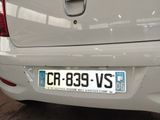 a white car that has a license plate on it
