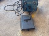 a machine that is sitting on the ground in the garage