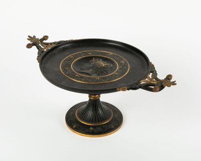 a black and gold plate with a bird on it