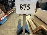 a close up of a sign on a dolly in a warehouse