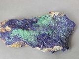 a close up of a piece of rock with blue and green speckles
