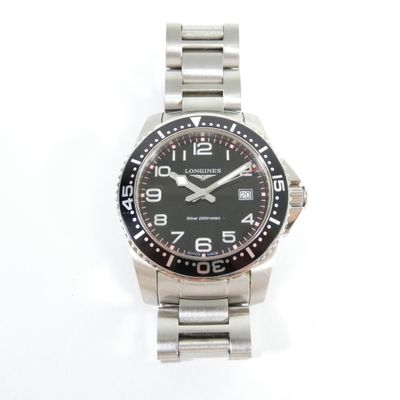 a close up of a watch on a white surface