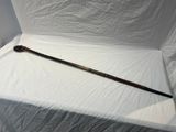a long wooden stick sitting on a white sheet