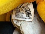 a yellow stuffed animal that is sitting in a bag