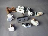 many small figurines of cats and dogs on a table
