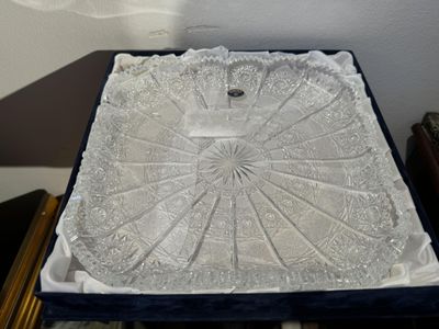 a white tray that has a white lace design on it