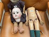 two dolls that are sitting on a chair together