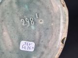 a close up of a vase with a tag on it